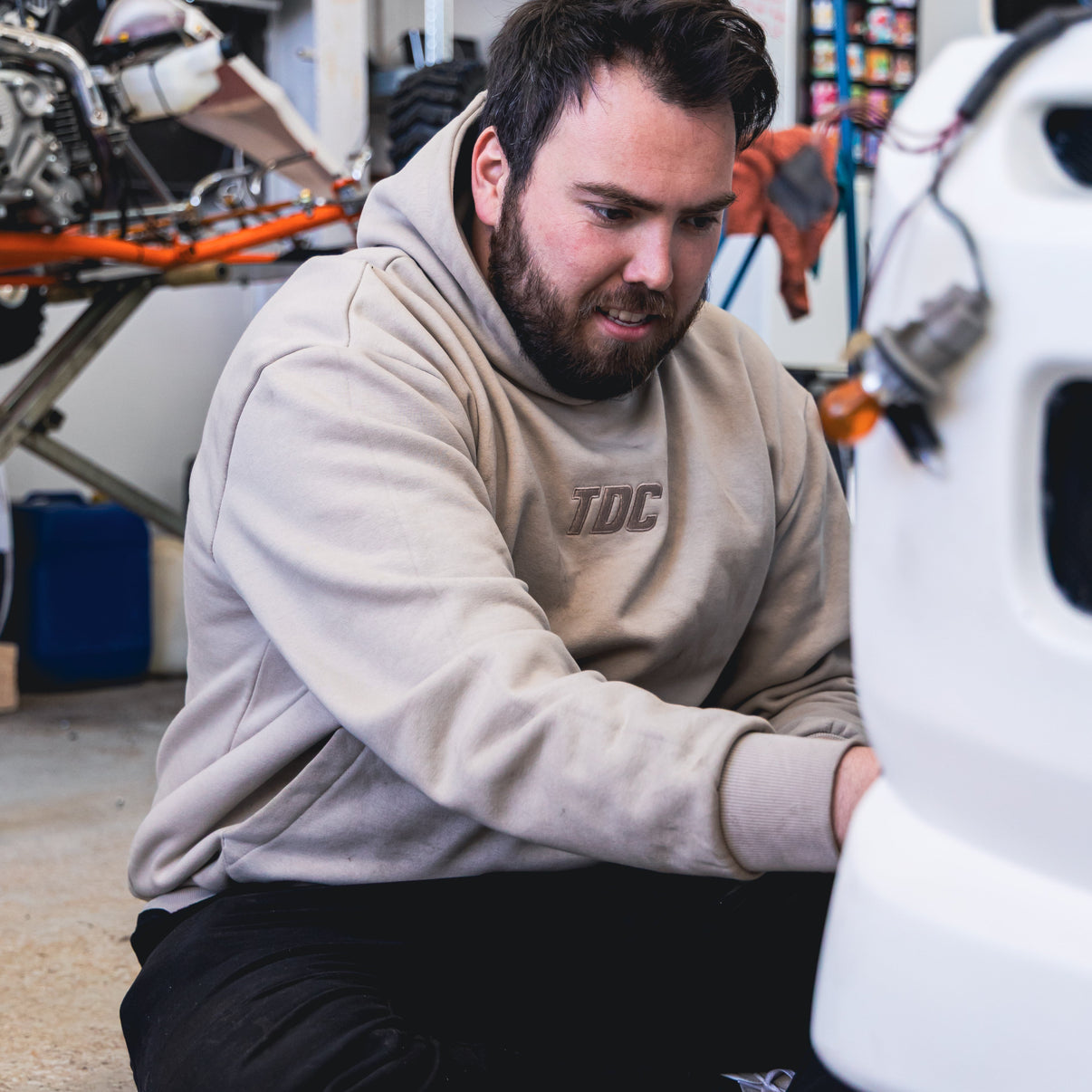Man working on a car tire in a garage
